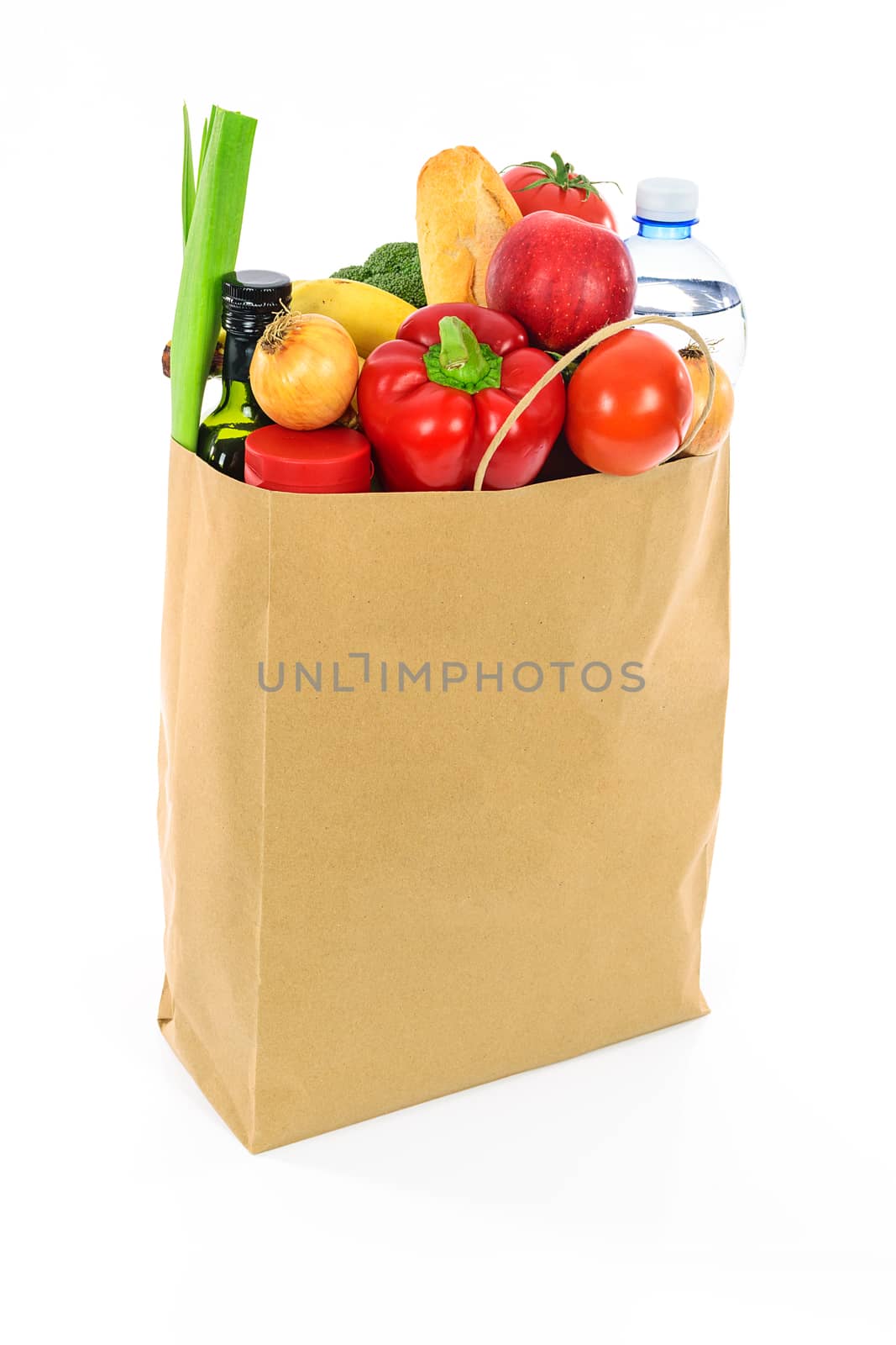 Grocery shopping concept image - Eco friendly paper shopping bag filled with various food products.