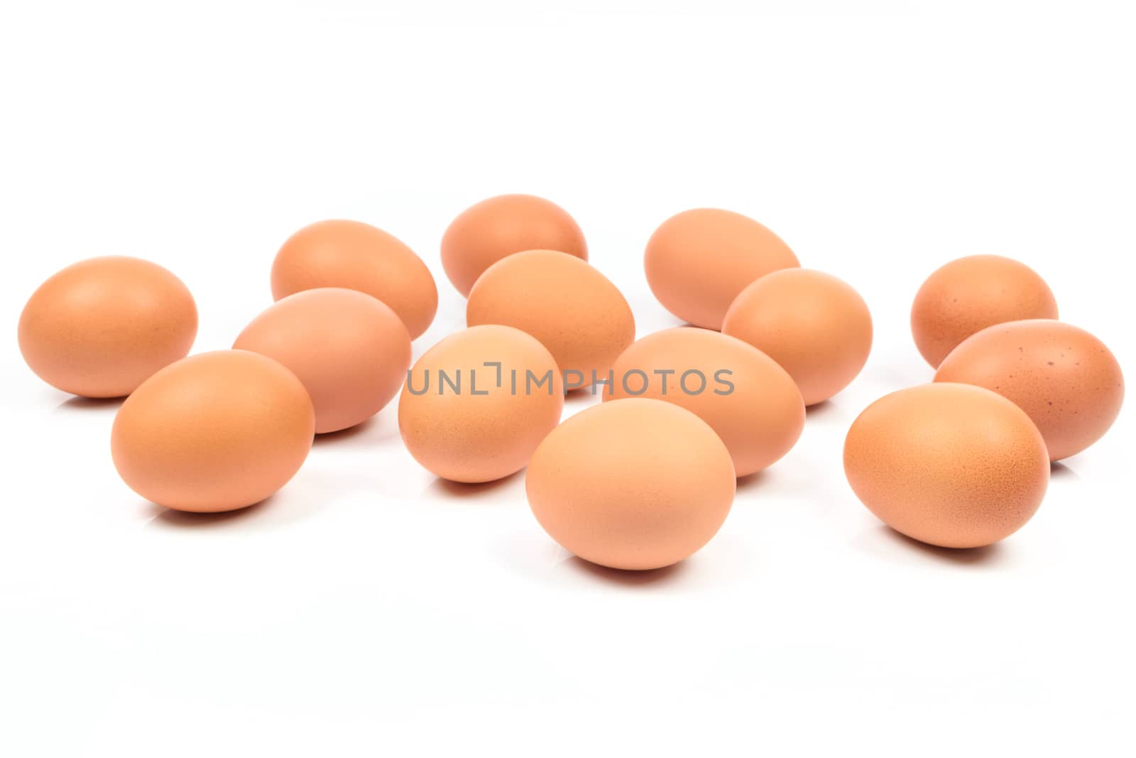 Large group of brown eggs isolated on a white background.