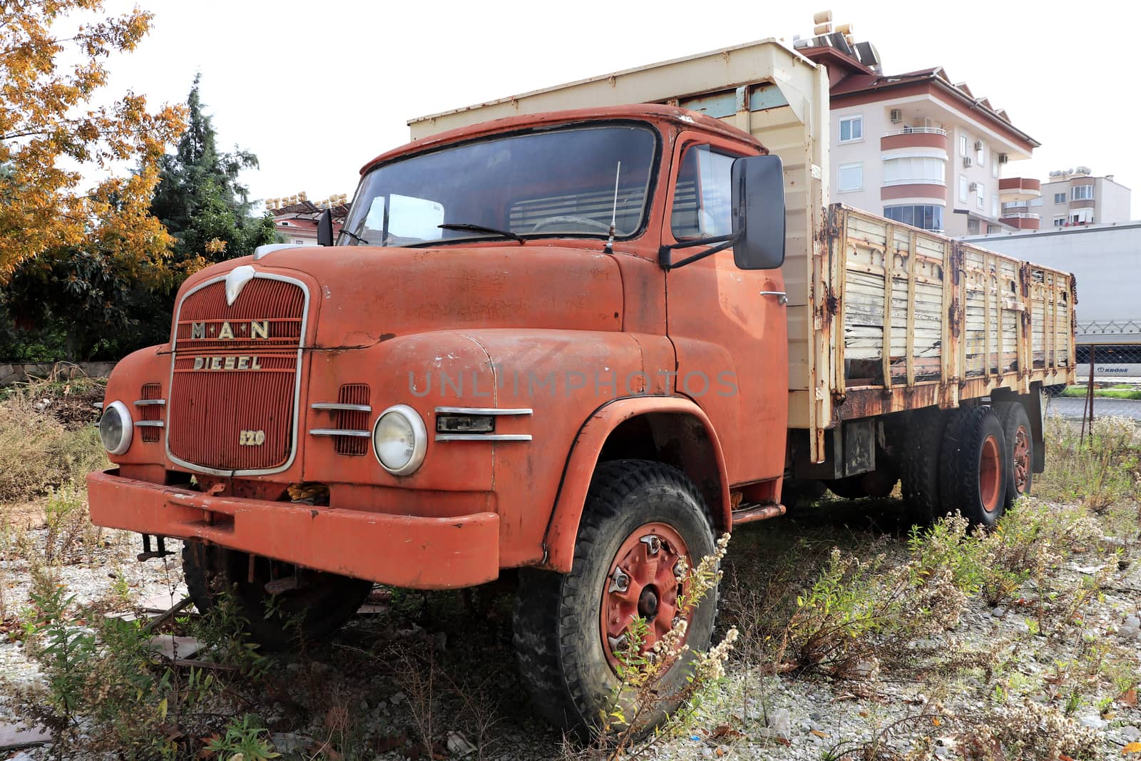 Weathered red retro rusty truck. Vintage aged vehicle.