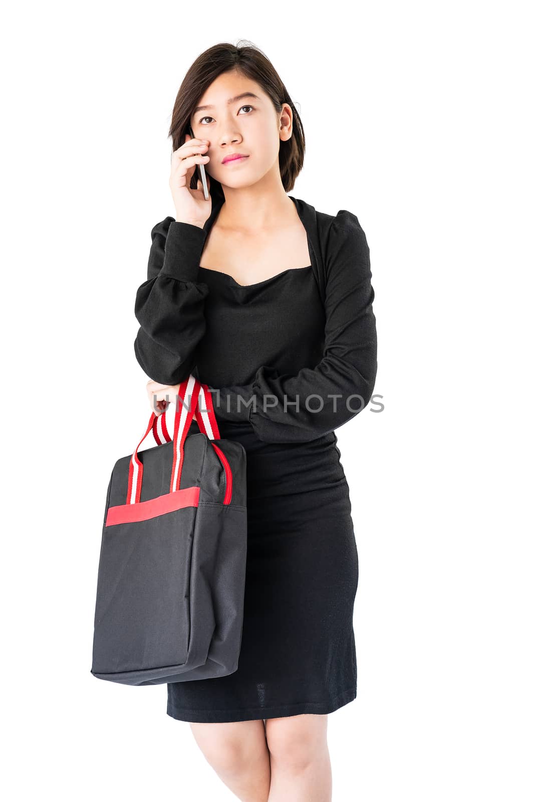 Woman carrying a black shopping bag using cellphone shopping onl by stoonn