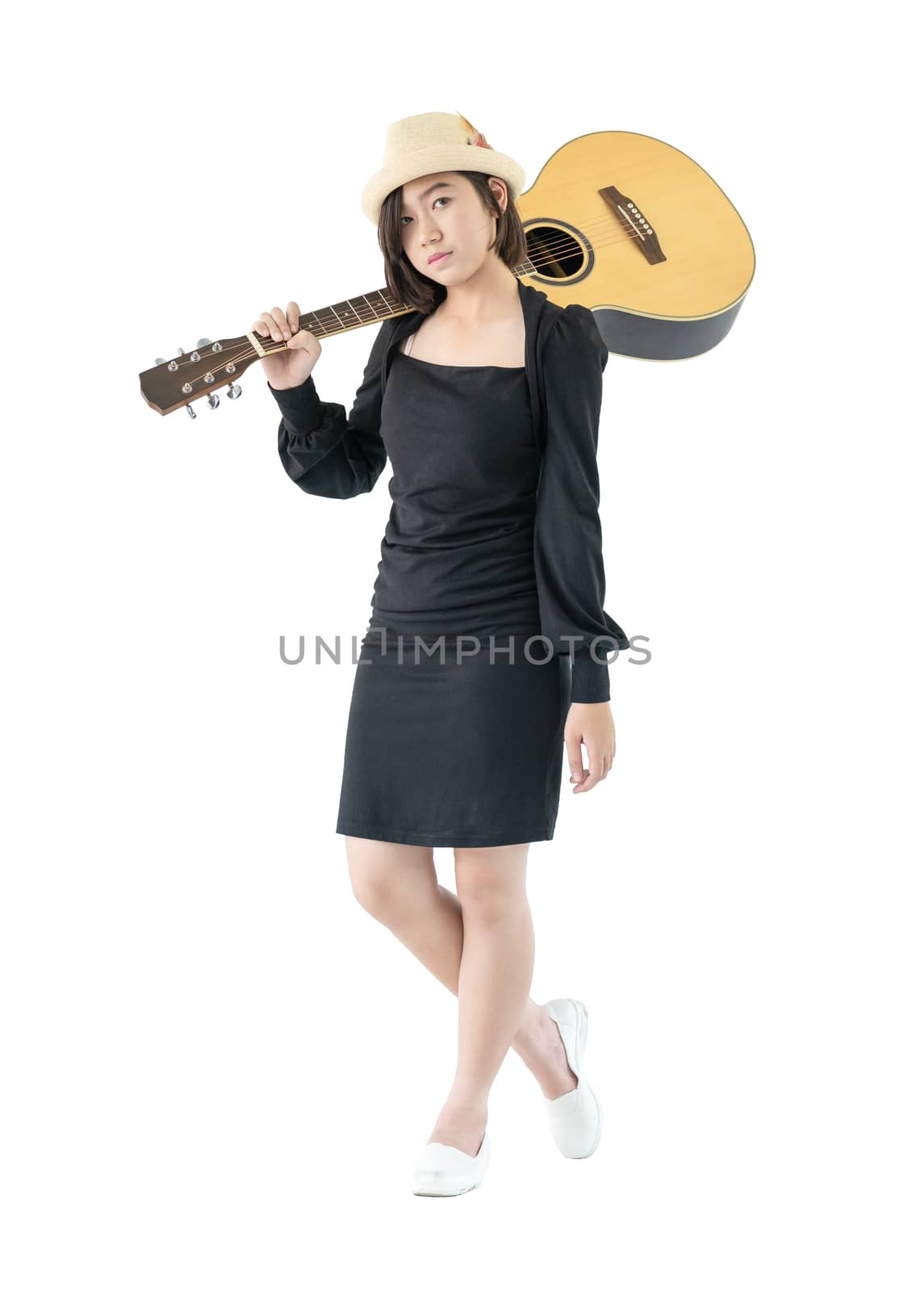 Woman carrying acoustic guitar on shoulder isolate on white background