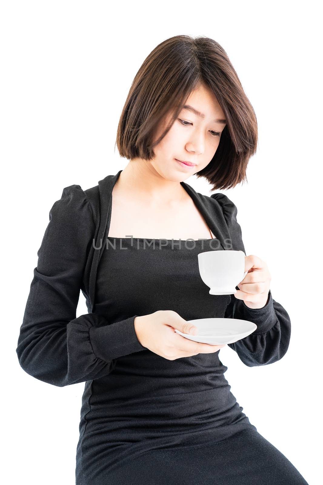 Young woman sittng holding coffee cup on white background