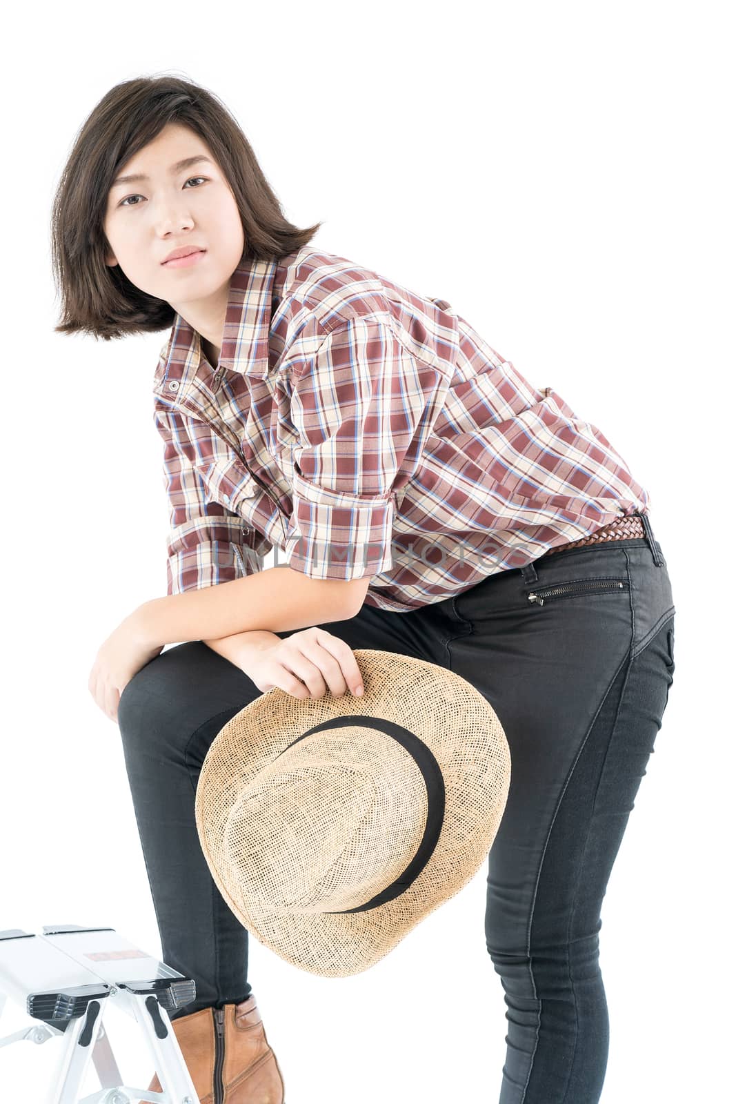 Young woman in a plaid shirt posing in studio on white backgroun by stoonn