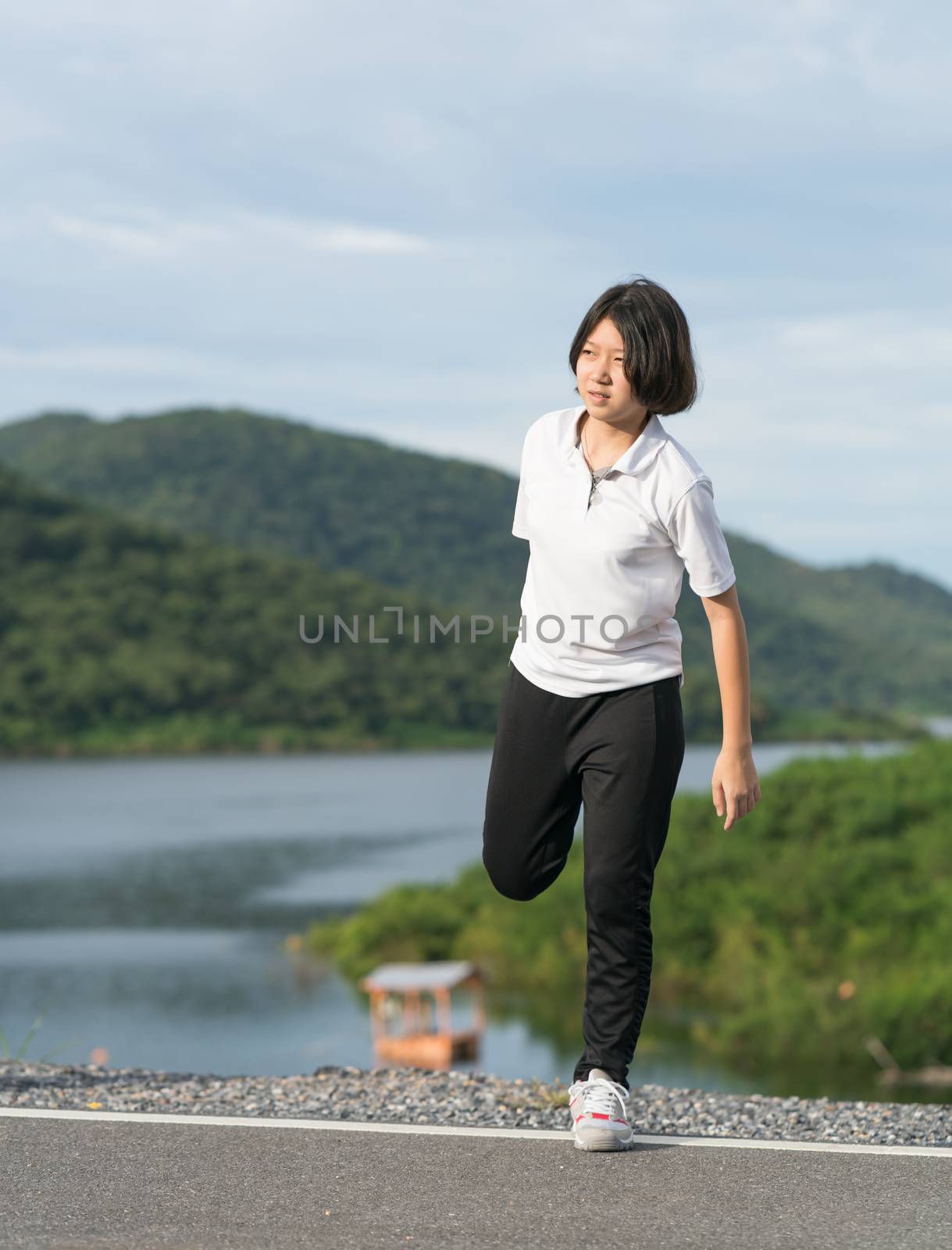 Woman short hair doing exercising outdoor by stoonn