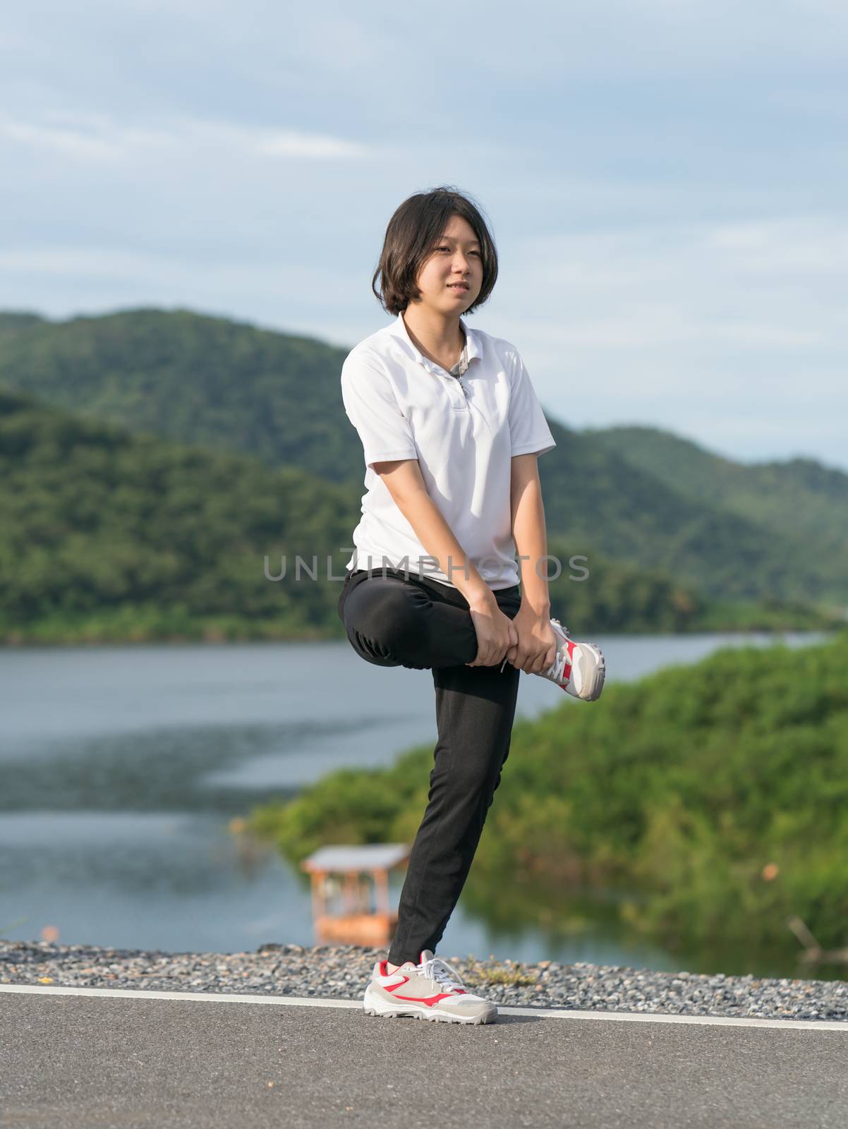 Woman short hair doing exercising outdoor by stoonn