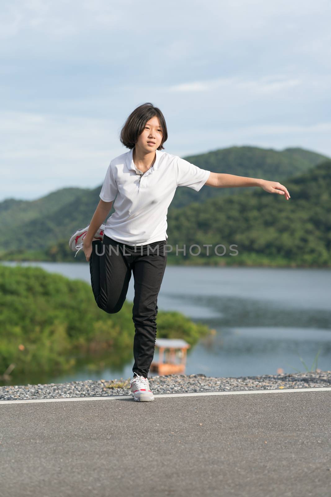 Woman short hair doing exercising outdoor by stoonn