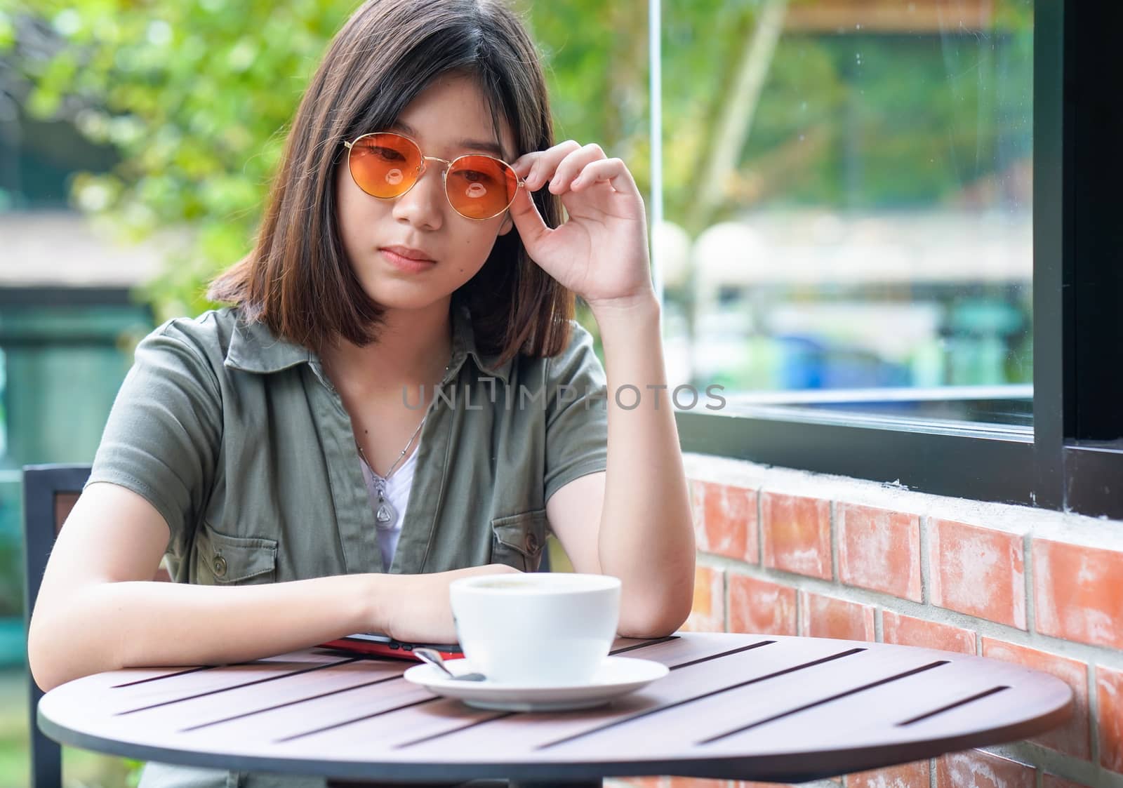 Pretty woman sitting in a cafe terrace with coffee cup