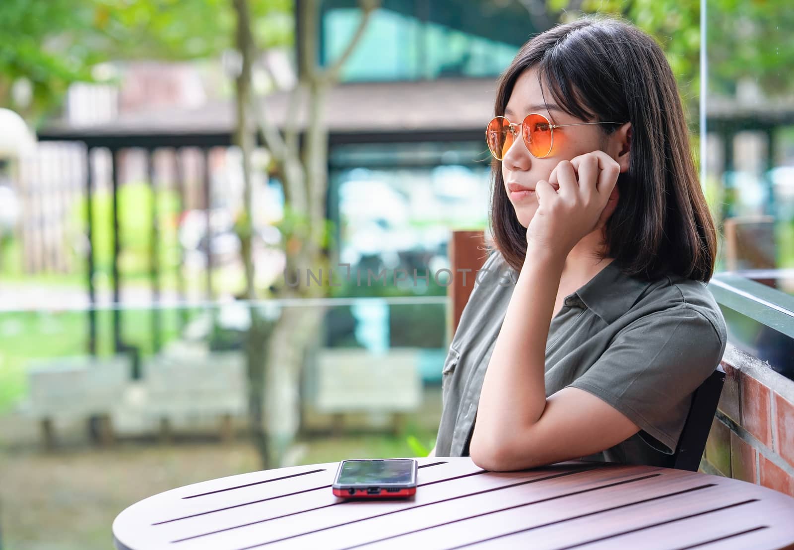 Pretty woman sitting in a cafe terrace use smartphone