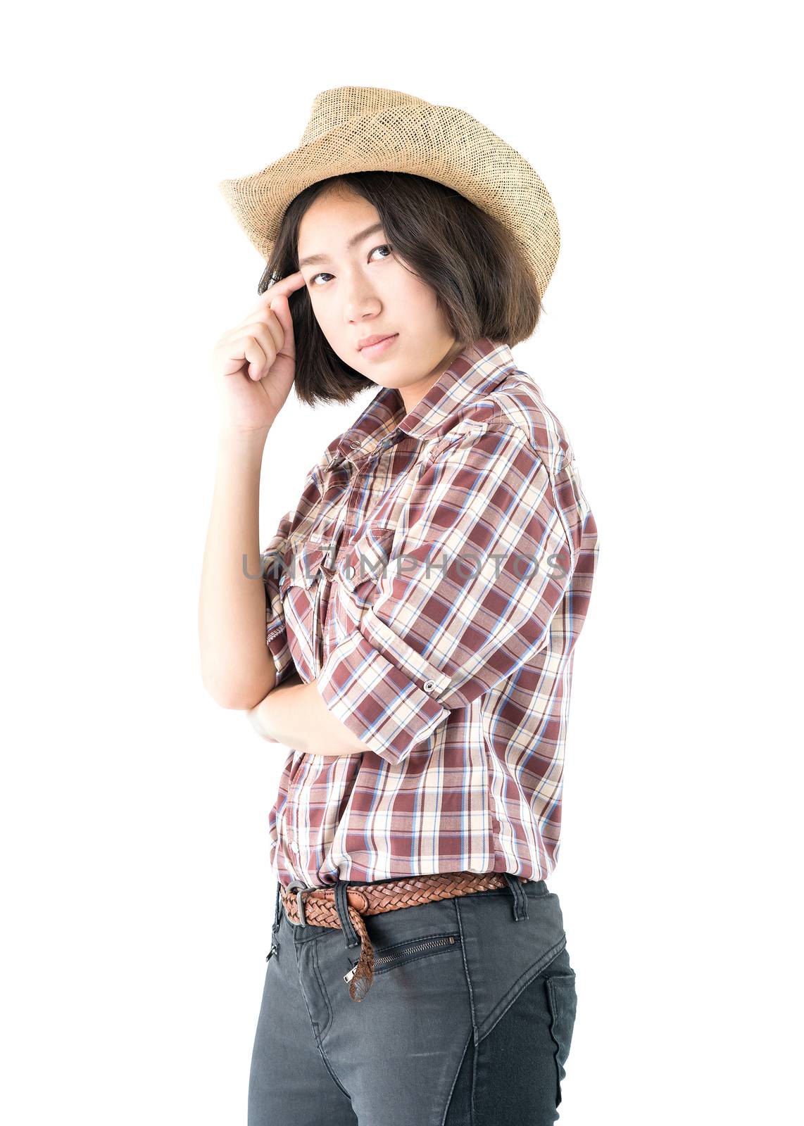 Young woman in a plaid shirt and arms crossed by stoonn