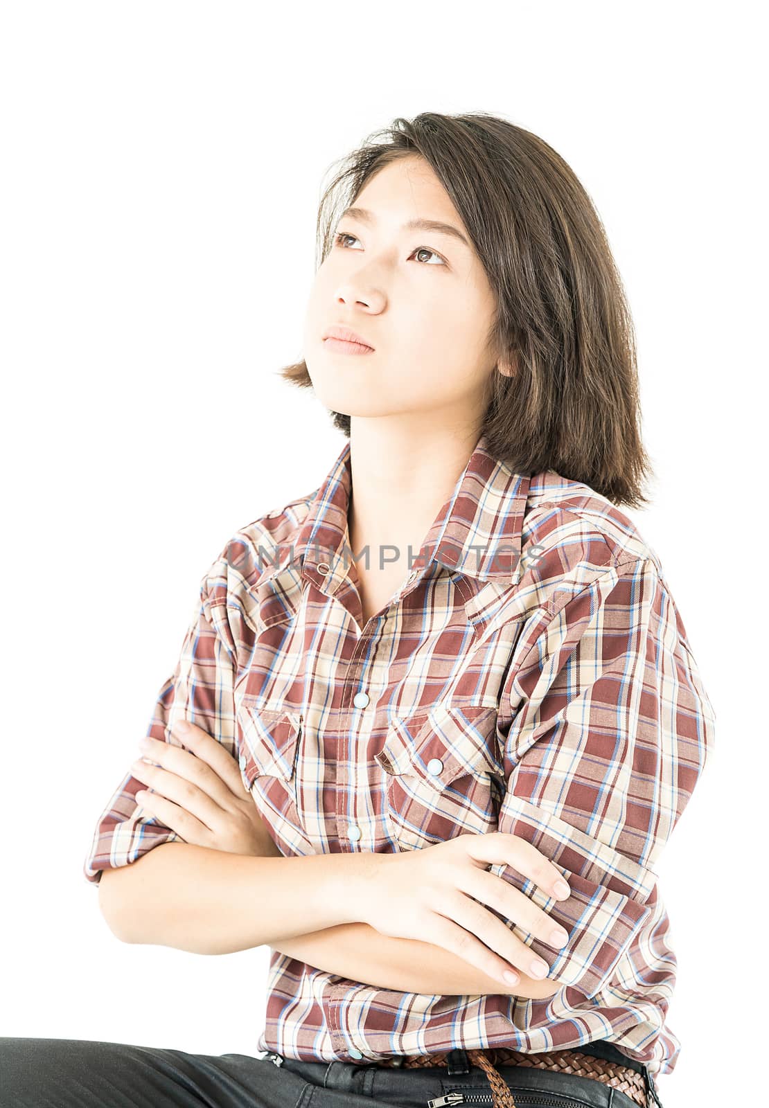 Young pretty woman in plaid shirt posing in studio with isolated on white background