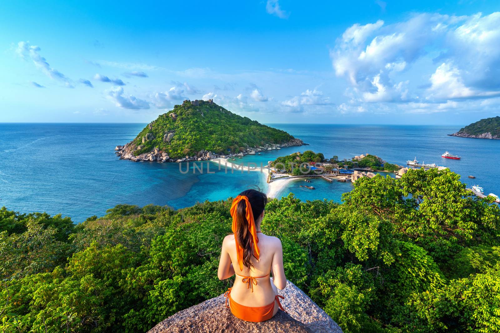 Woman in bikini sitting at the viewpoint of Nang yuan island, Thailand.