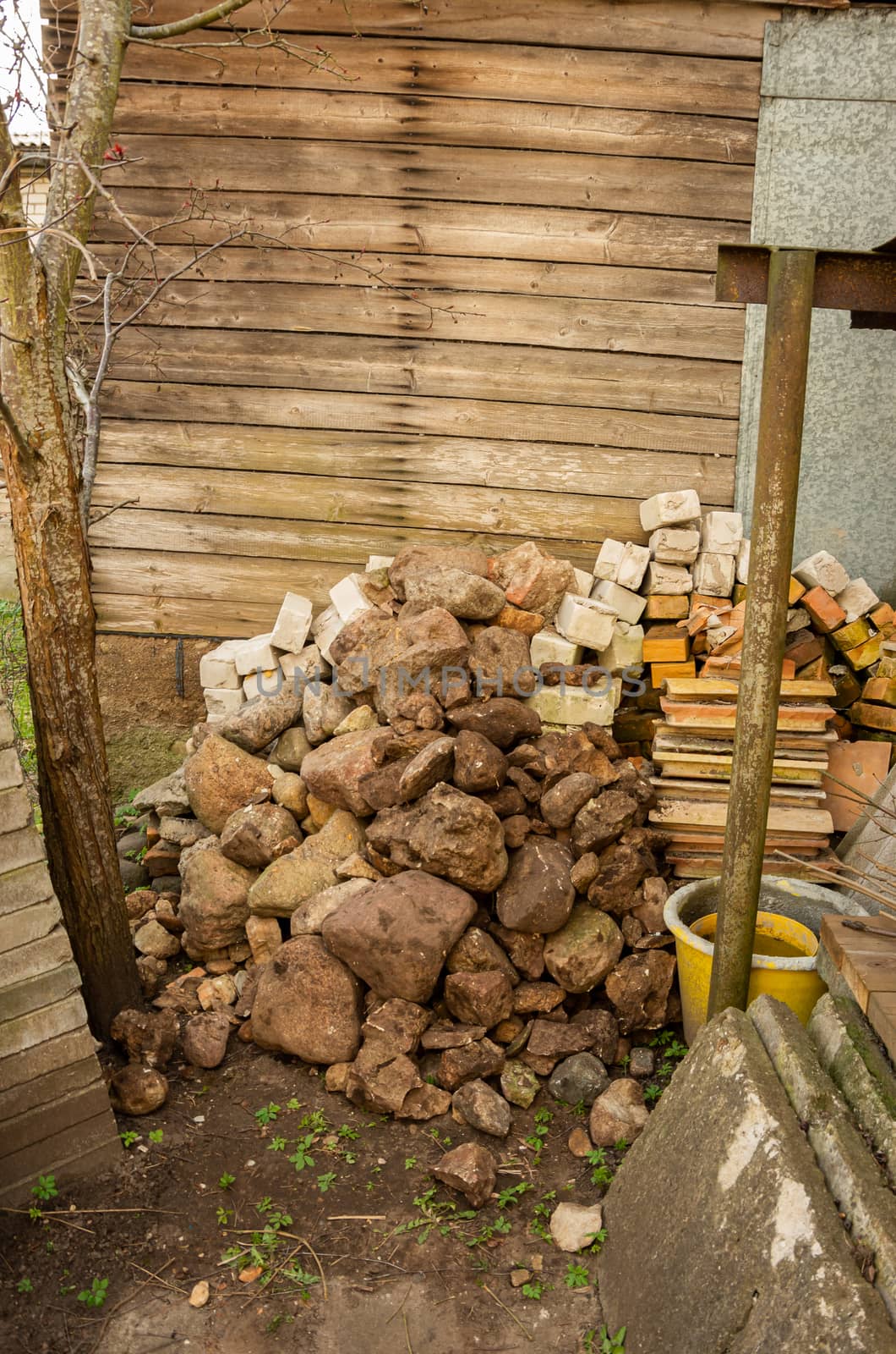 Stack of stones, various garden things, buckets