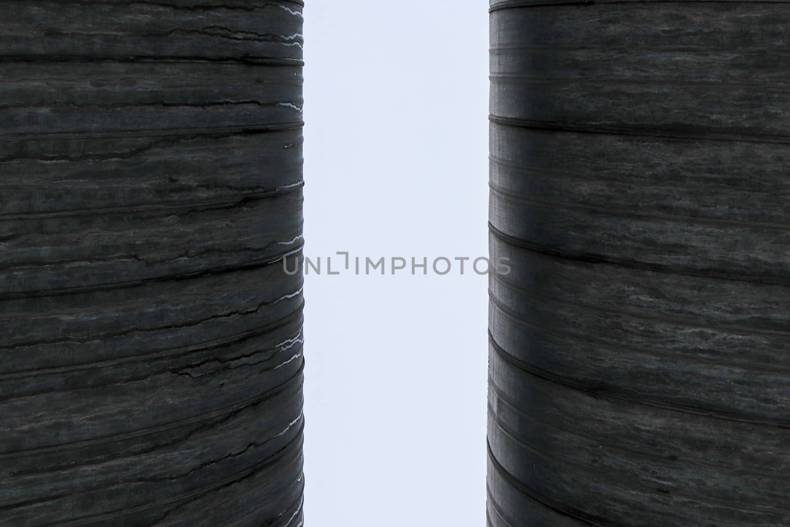 Two metal pipes with clearance background.