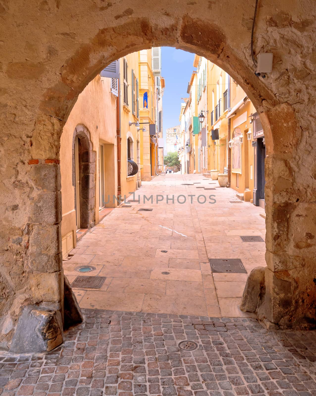 Saint Tropez historic town gate and colorful street view, tourist destination of French riviera