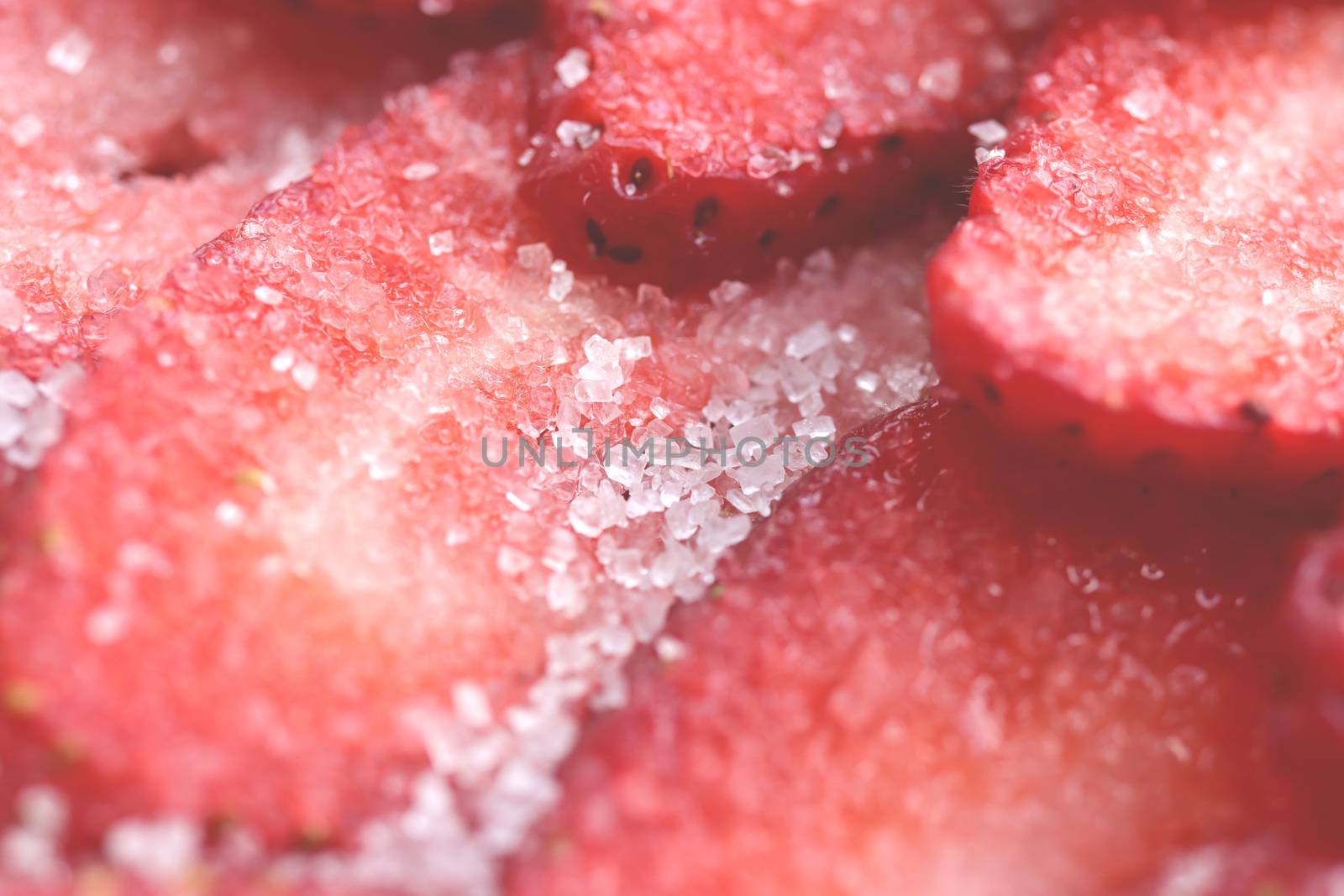 Sliced strawberry in sugar filling background. Red healthy tasty strawberry’s with sugar texture. Fresh vitamin berry backdrop.