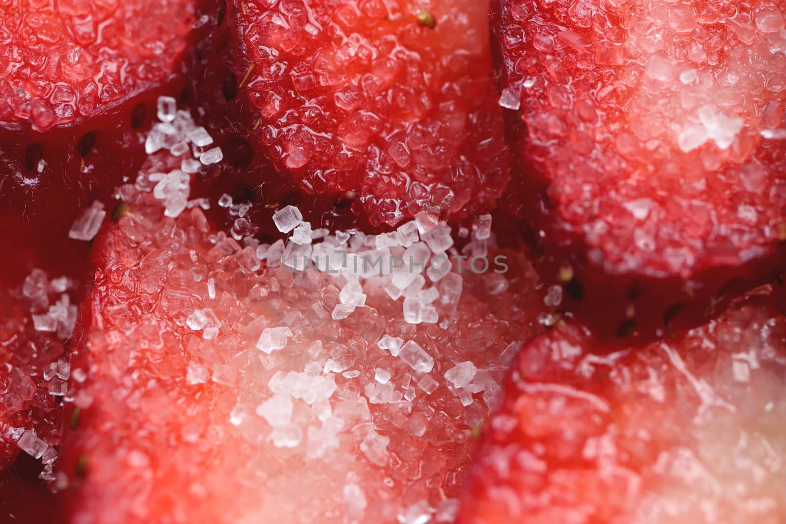 Sliced strawberry in sugar filling background. Red healthy tasty strawberry’s with sugar texture. Fresh vitamin berry backdrop.