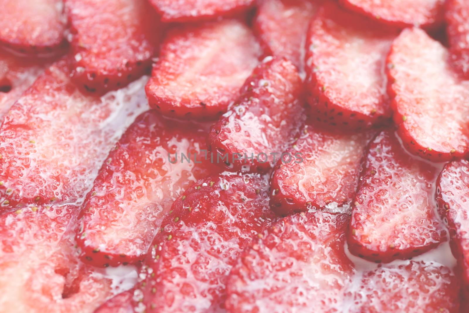 Fresh vitamin berry backdrop. Sliced strawberry in sugar cream filling background. Red healthy tasty strawberry’s with sugar plum texture.