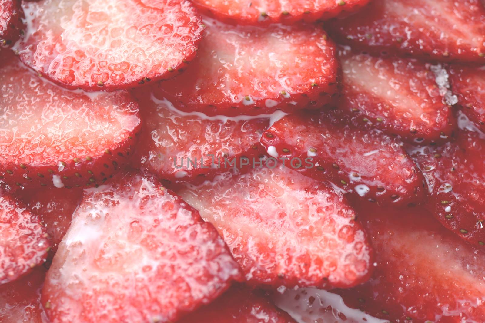 Red healthy tasty strawberry’s with sugar plum texture. Fresh vitamin berry backdrop. Sliced strawberry in sugar cream filling background.