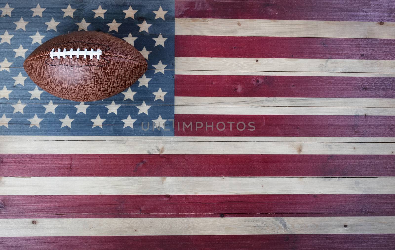 American football equipment on vintage wooden US flag background. USA sports concept with copy space