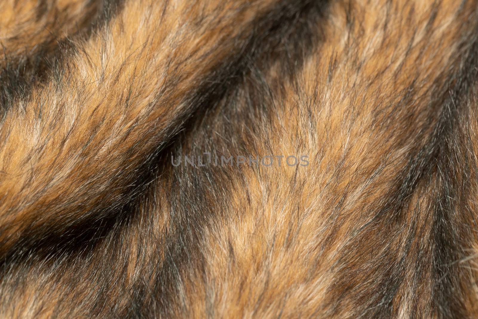 Close-up of a fluffy dark brown faux fur fabric with a background texture. by bonilook