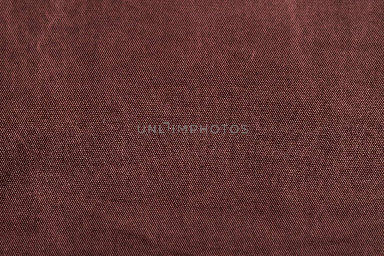 Dark cherry Denim Texture. Denim background of jeans of unusual color, place for text, place for copying.