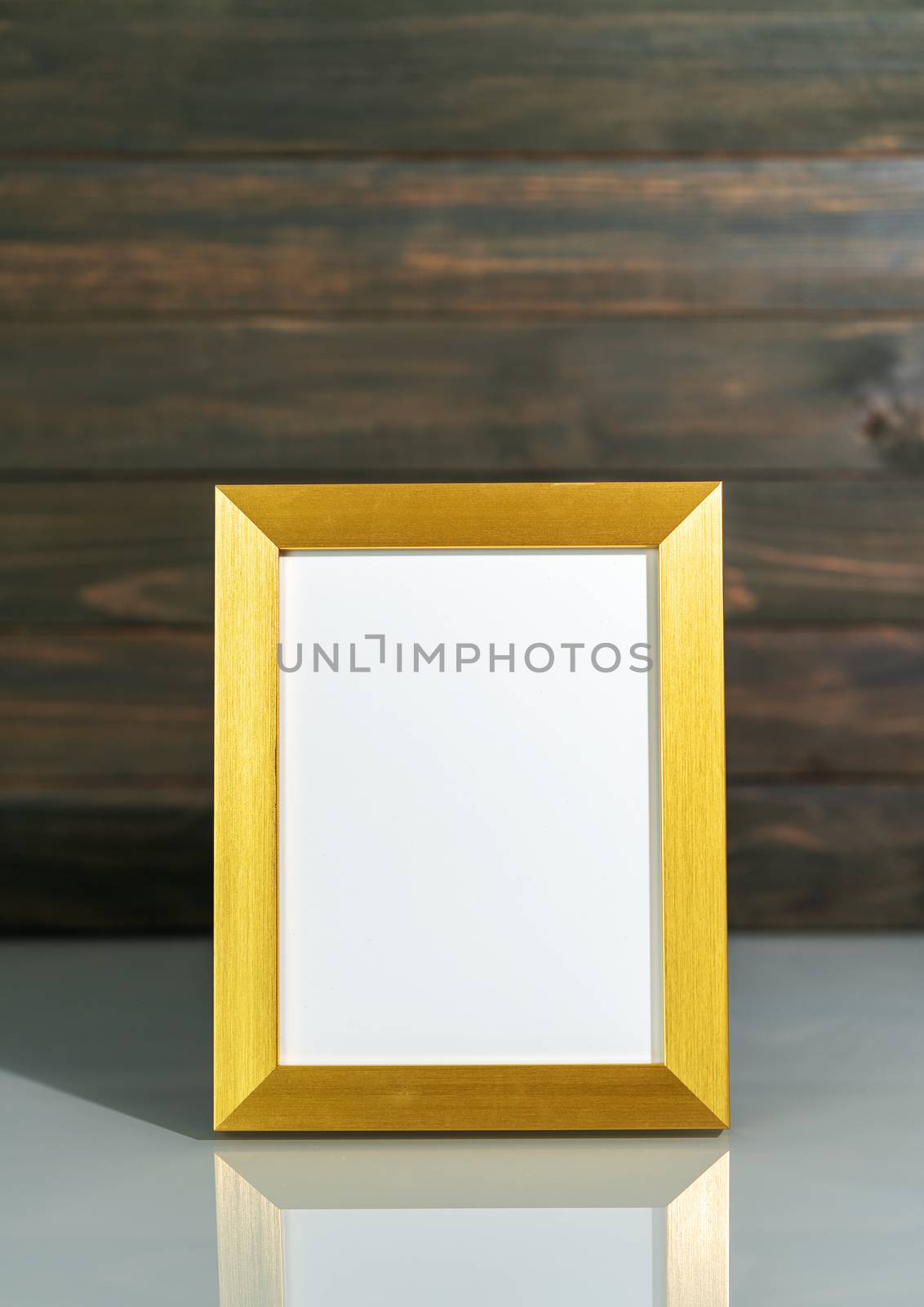 Picture golden frame mock up over table with wood wall background