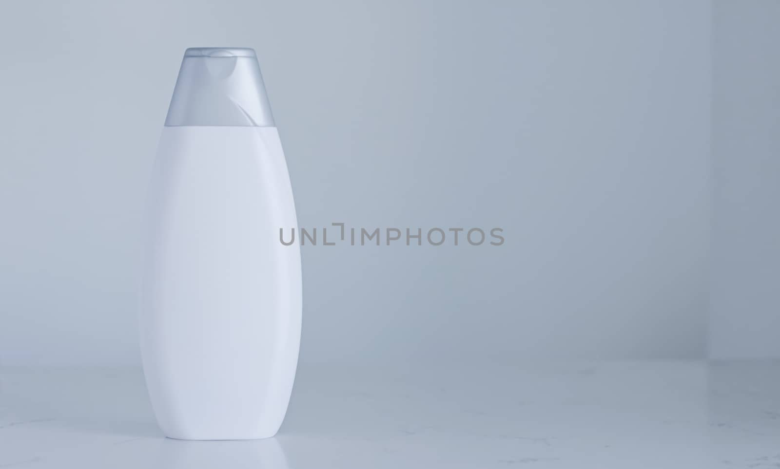 Blank label cosmetic container bottle as product mockup on gray background, hygiene and healthcare