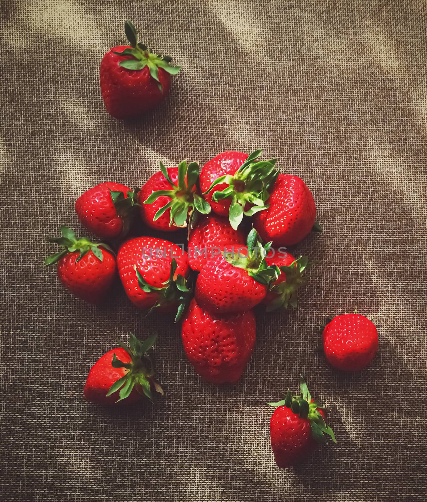 Organic strawberries on rustic linen background by Anneleven