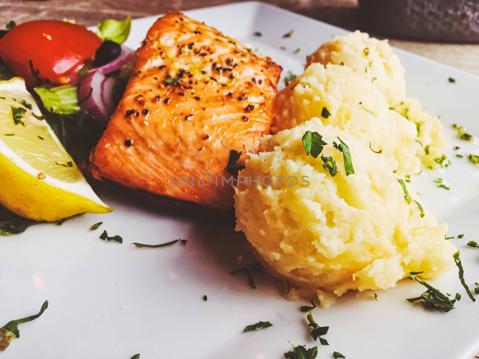 Grilled salmon, mashed potatoes and salad for lunch, served meal