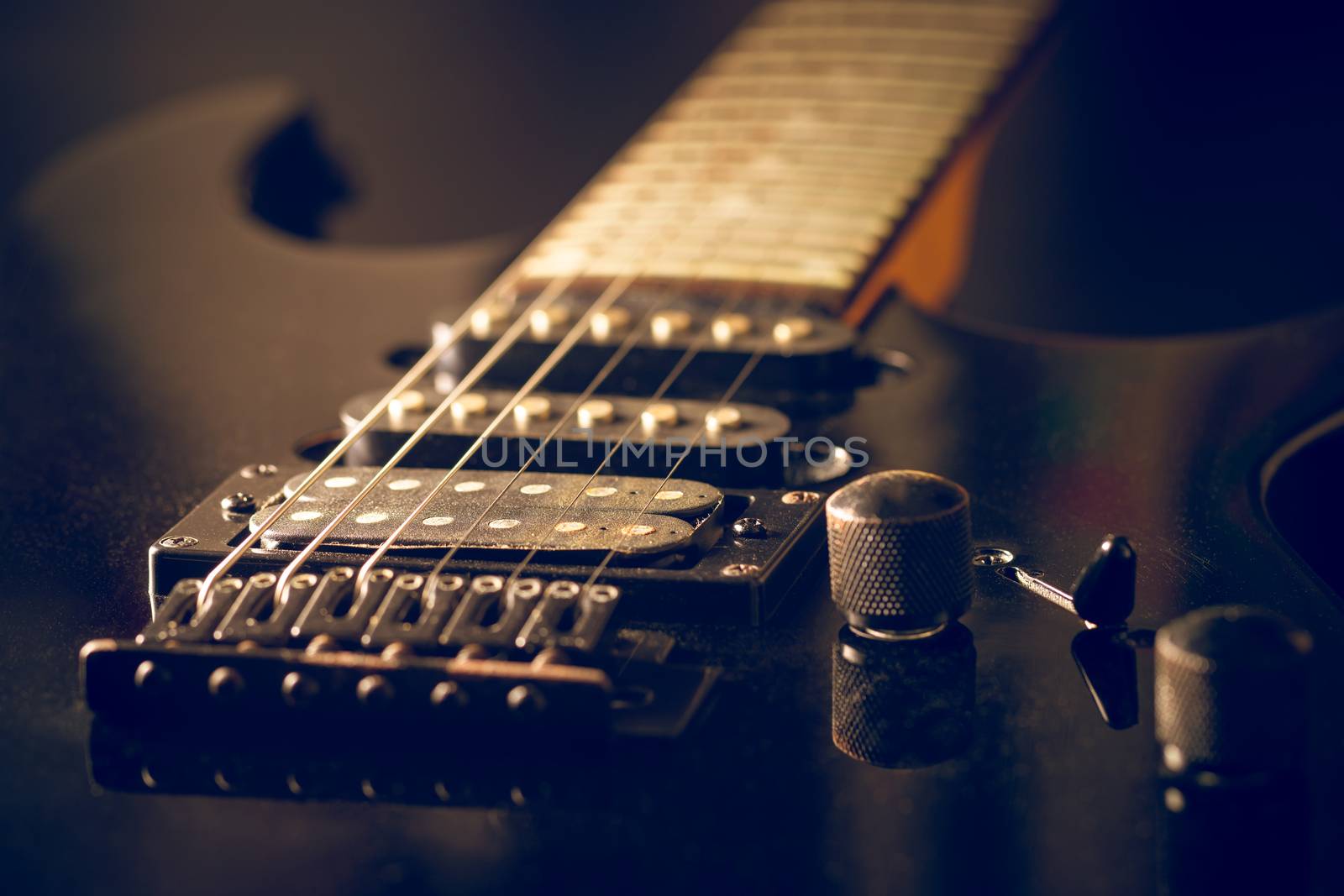 Black vintage electric guitar in dark. by SaitanSainam