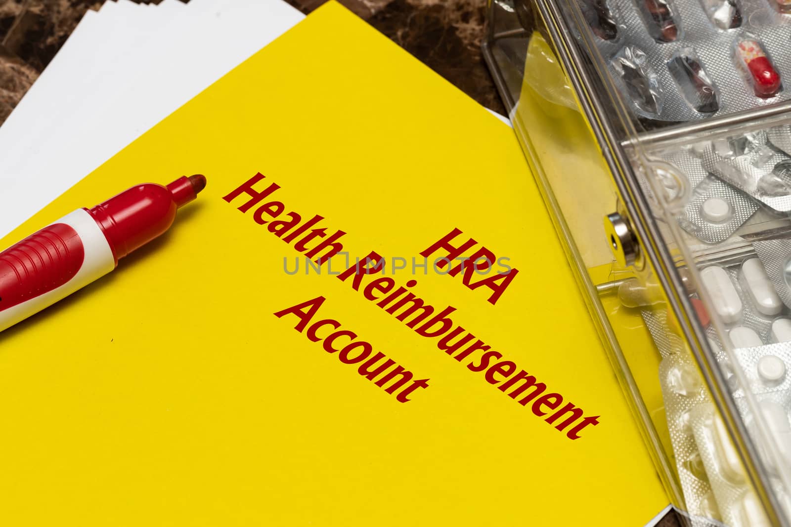 Health Reimbursement Account HRA, the text is written in red letters on a yellow sheet. by bonilook