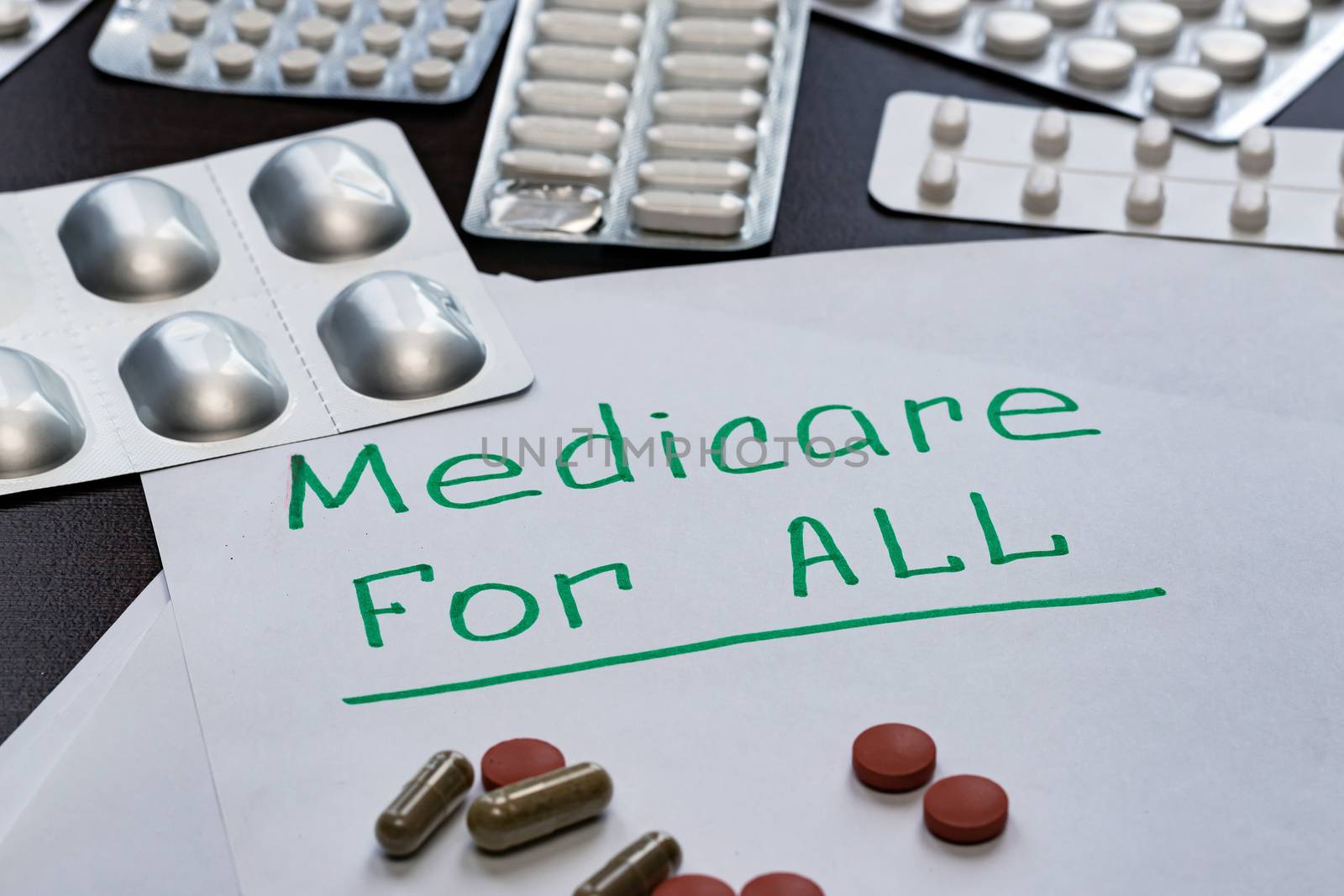 The Medicare for all sign is written on the sheet in green letters, by bonilook