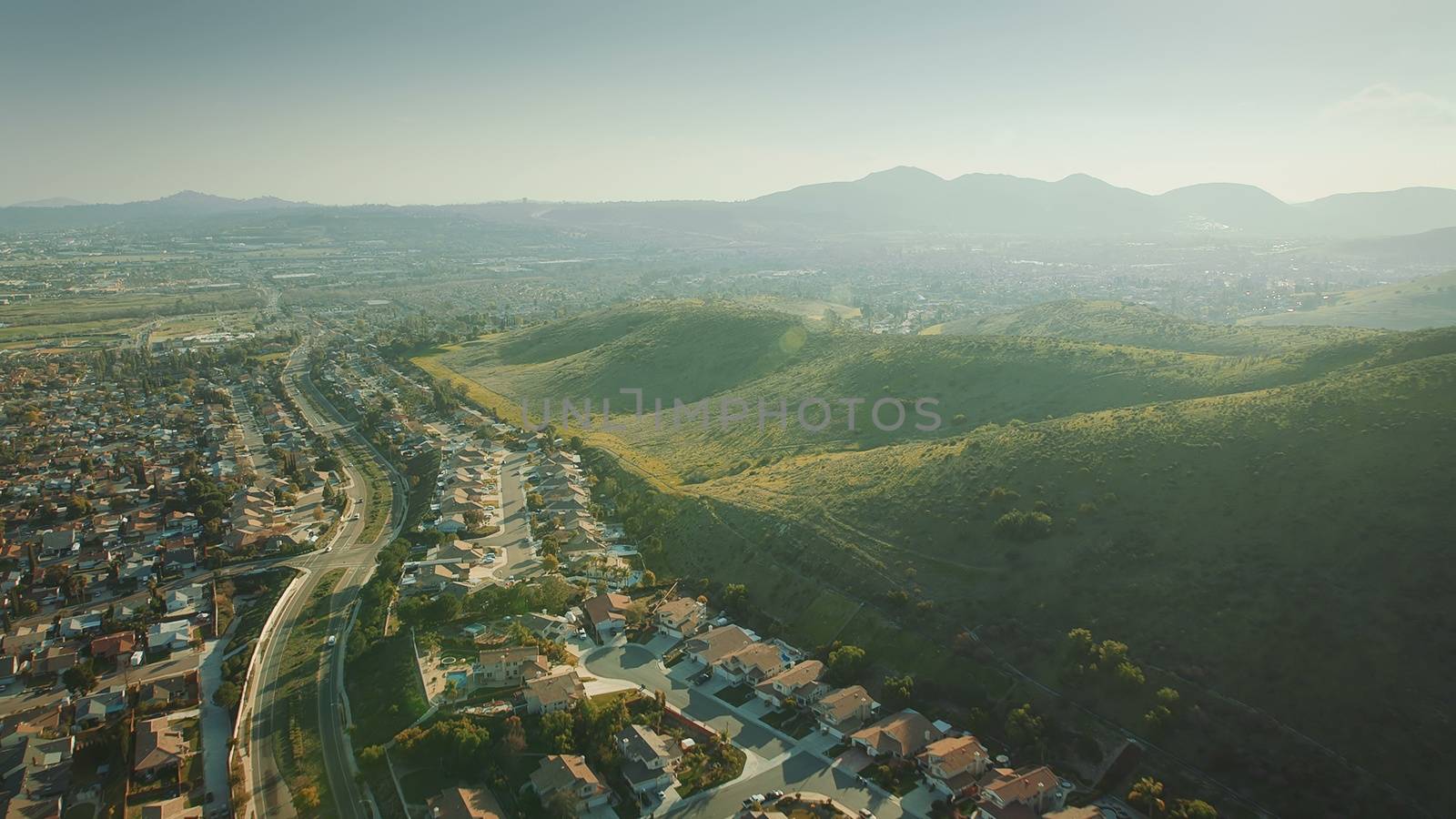 Aerial Flying over California Suburb. Aerial Landscape View For City and Mountain. by bhavik_jagani