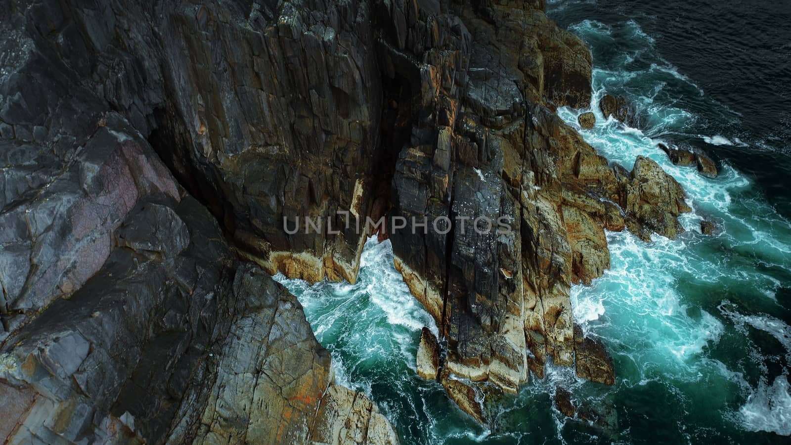 Tilt Up Along Ireland Coast - Waves Crashing on Cliffside by bhavik_jagani