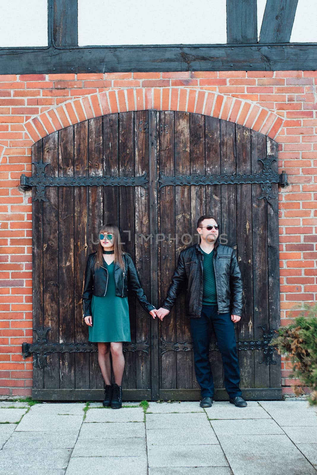 happy guy and girl walking along the tourist streets of old Europe in the city of Gdansk