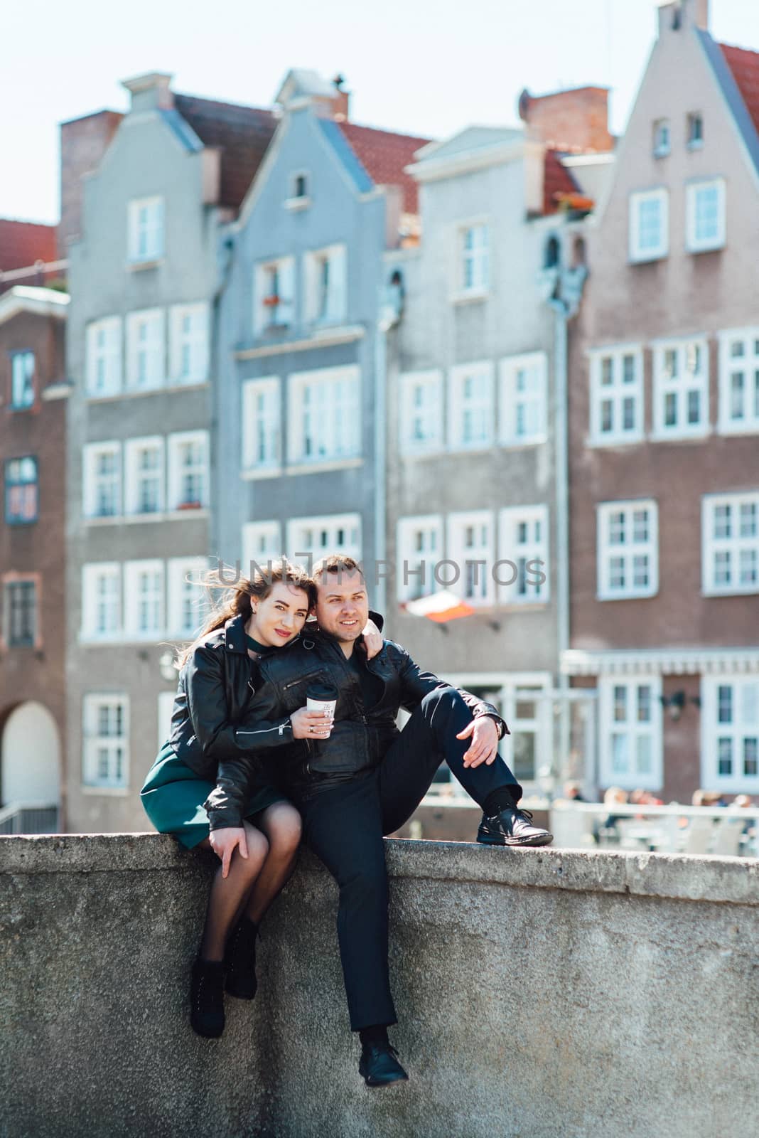 happy guy and girl walking along the tourist streets of old Euro by Andreua