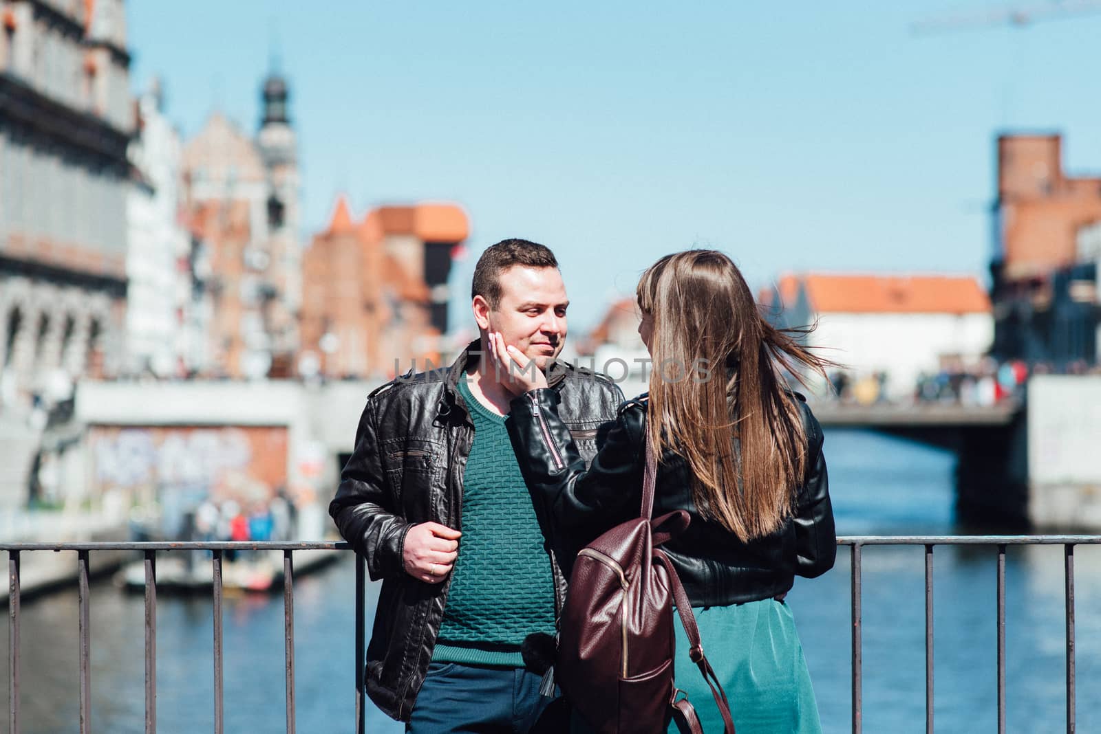 happy guy and girl walking along the tourist streets of old Europe in the city of Gdansk