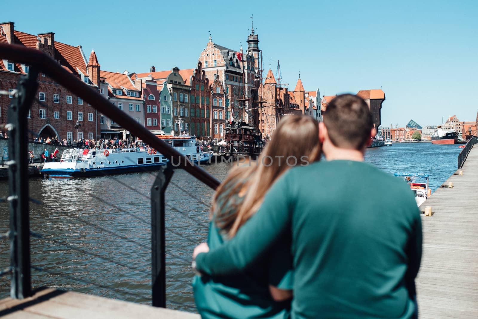 happy guy and girl walking along the tourist streets of old Europe in the city of Gdansk