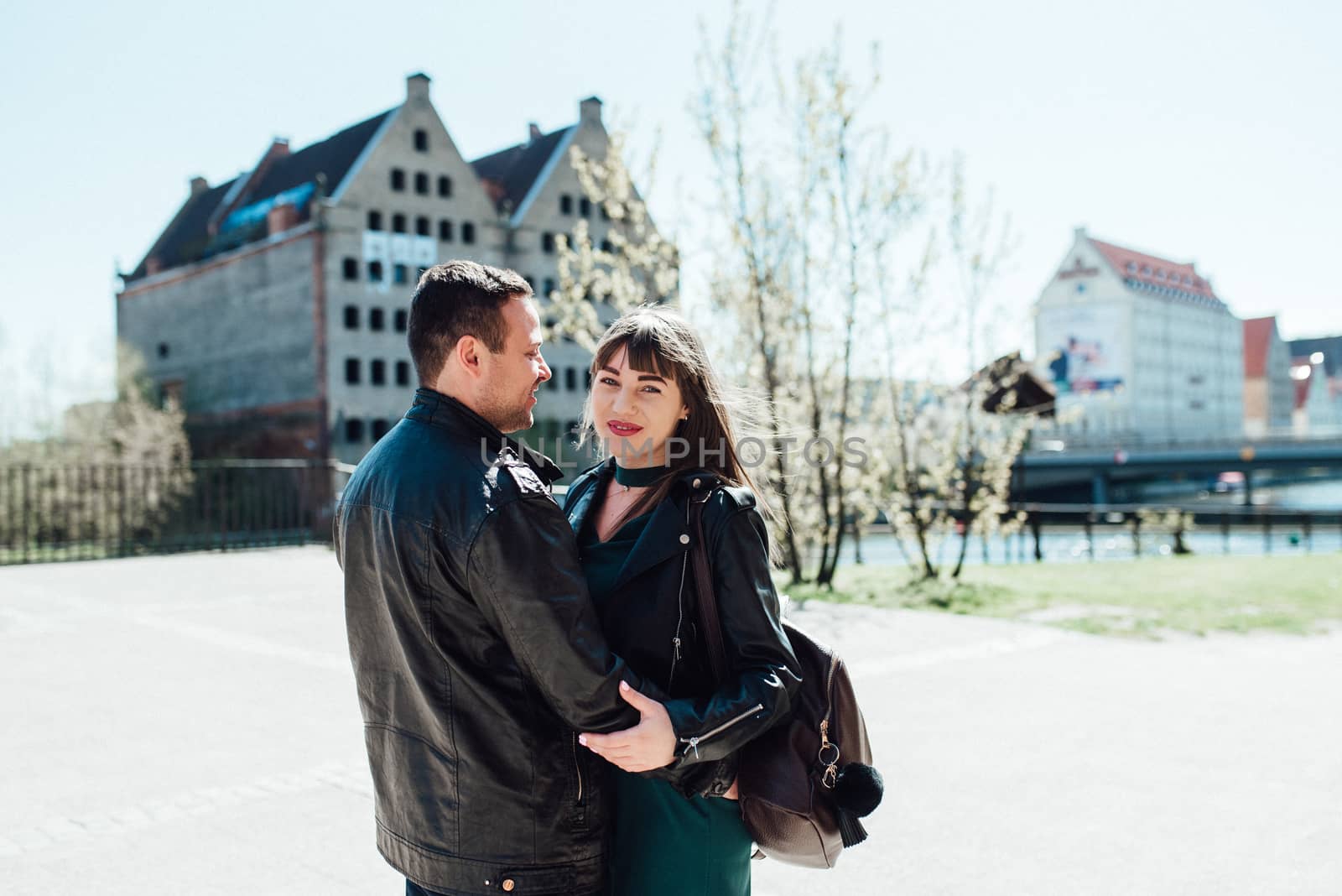 happy guy and girl walking along the tourist streets of old Euro by Andreua