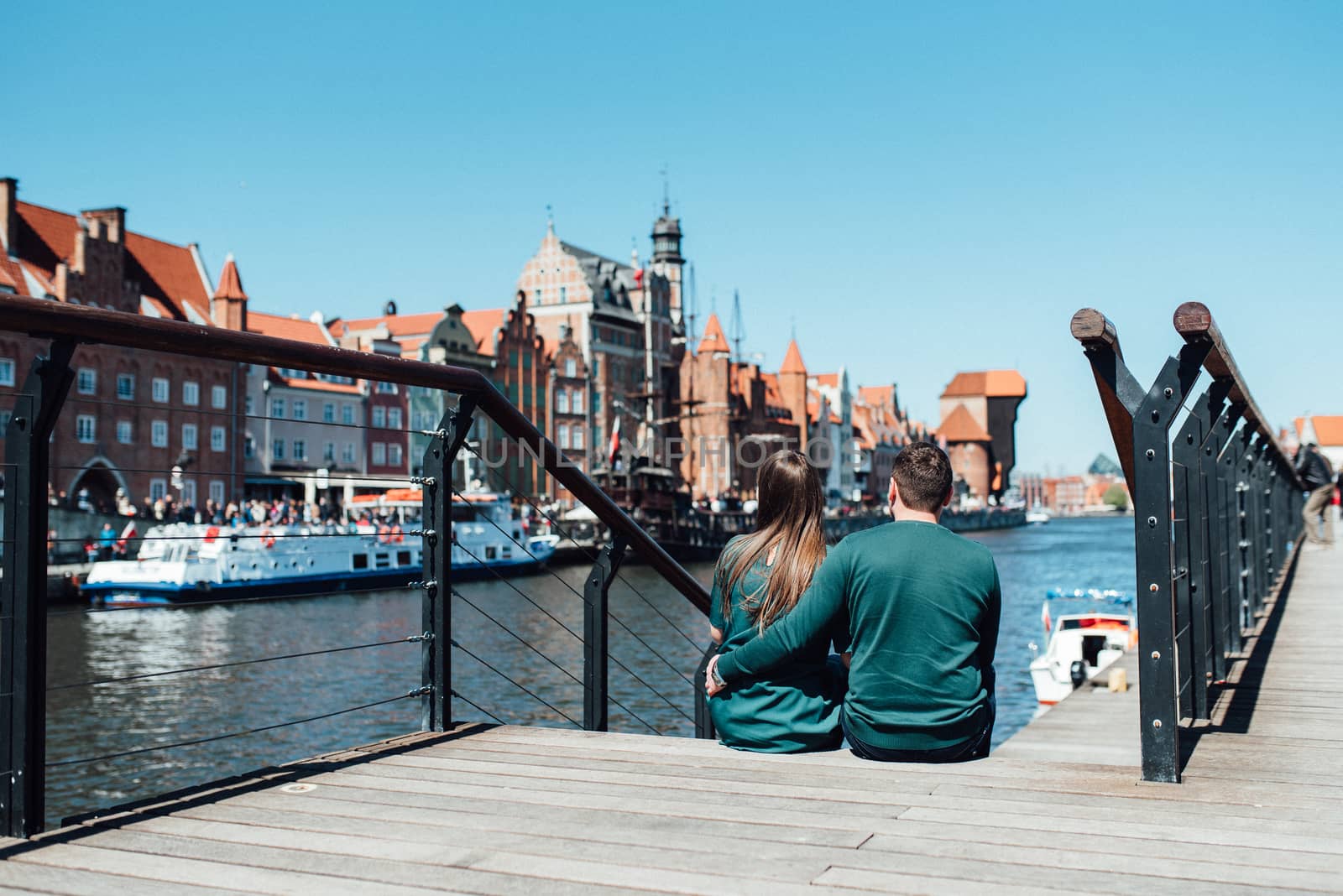 happy guy and girl walking along the tourist streets of old Euro by Andreua