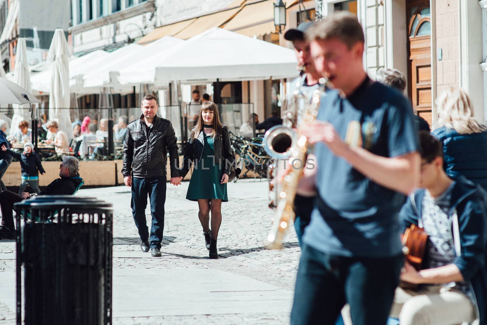 happy guy and girl walking along the tourist streets of old Europe in the city of Gdansk