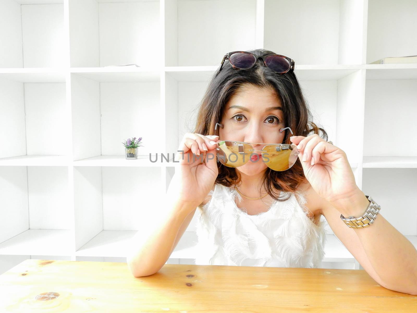 Beautiful woman and the eyeglasses against white background.
