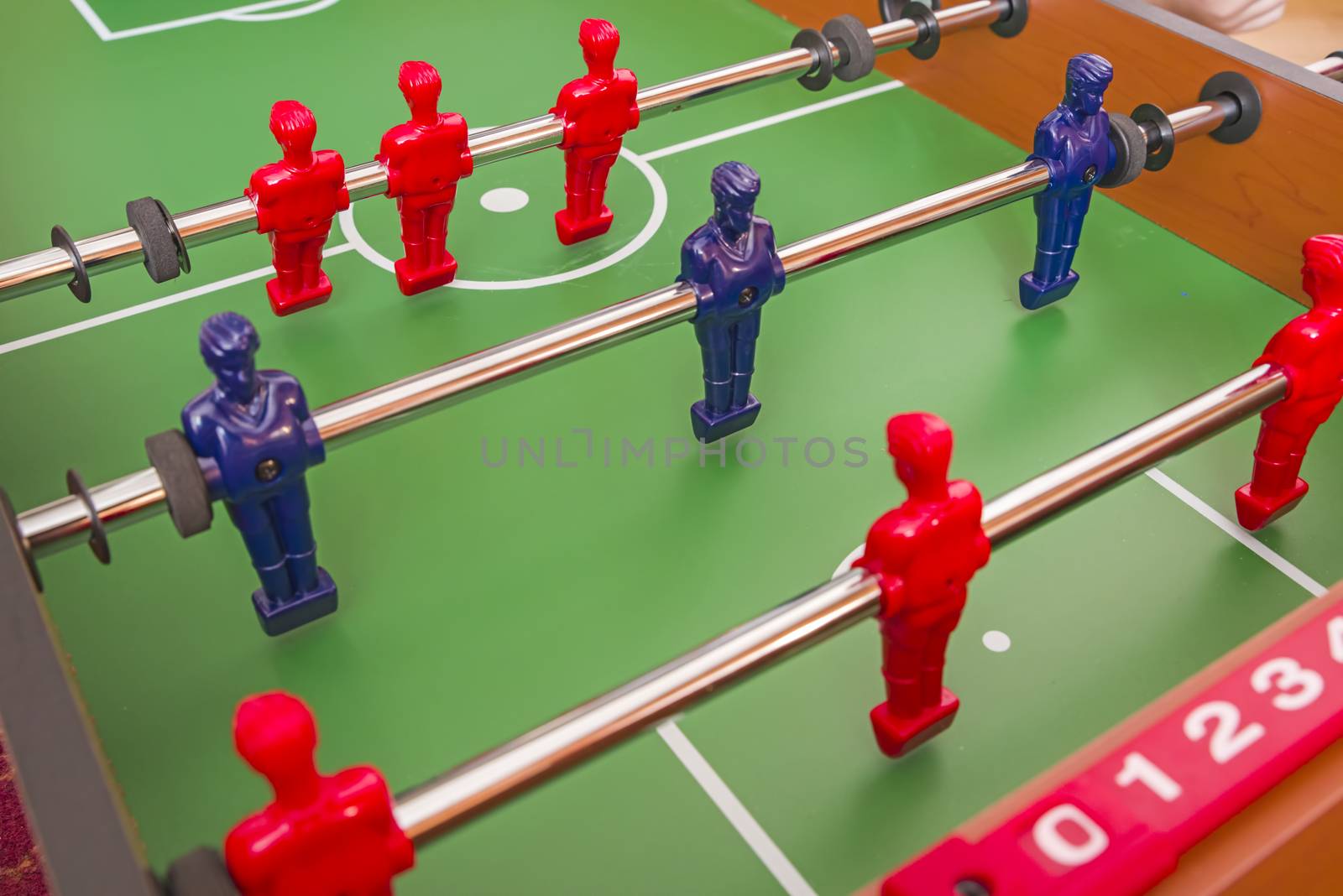 Installing figurine lines at football table game, close image
