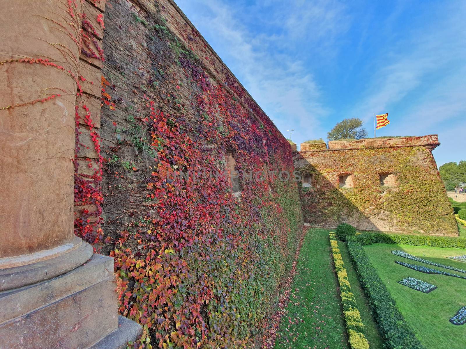 Green yard and ancient fortification, Montjuic Castle, well known landmark in Barcelona.
