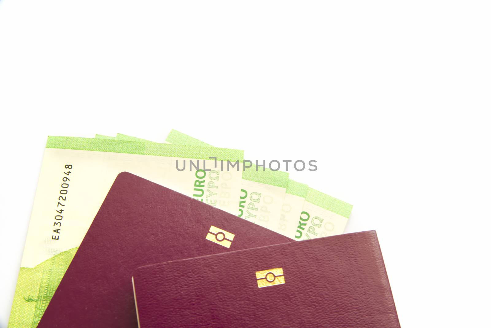 Euro banknotes in biometric passport over white background