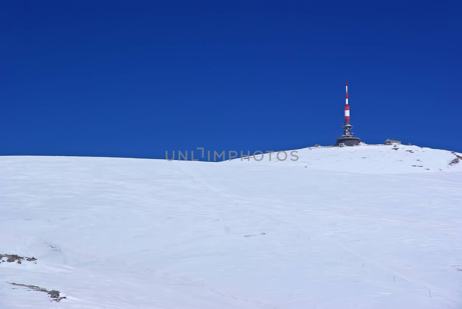 Transmission tower and meteorologic station on white mountain summit, Romanian Carpathians in winter