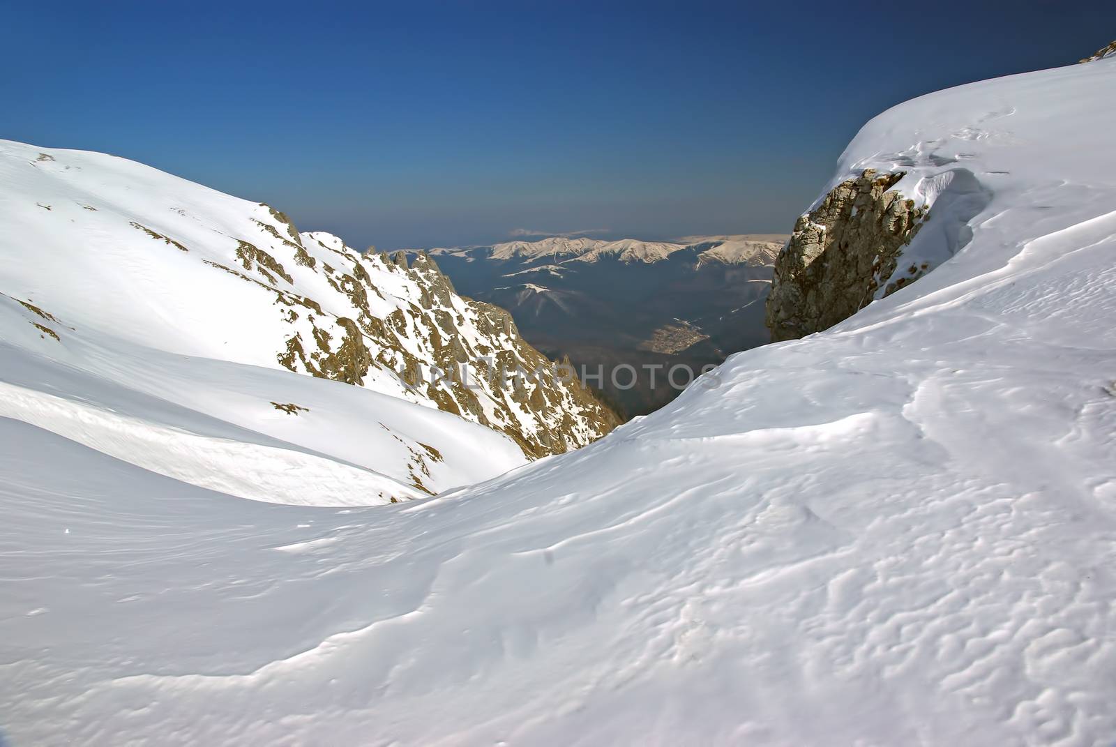 Winter mountain crest and snow corniche formed by wind, Romanian Carpathians
