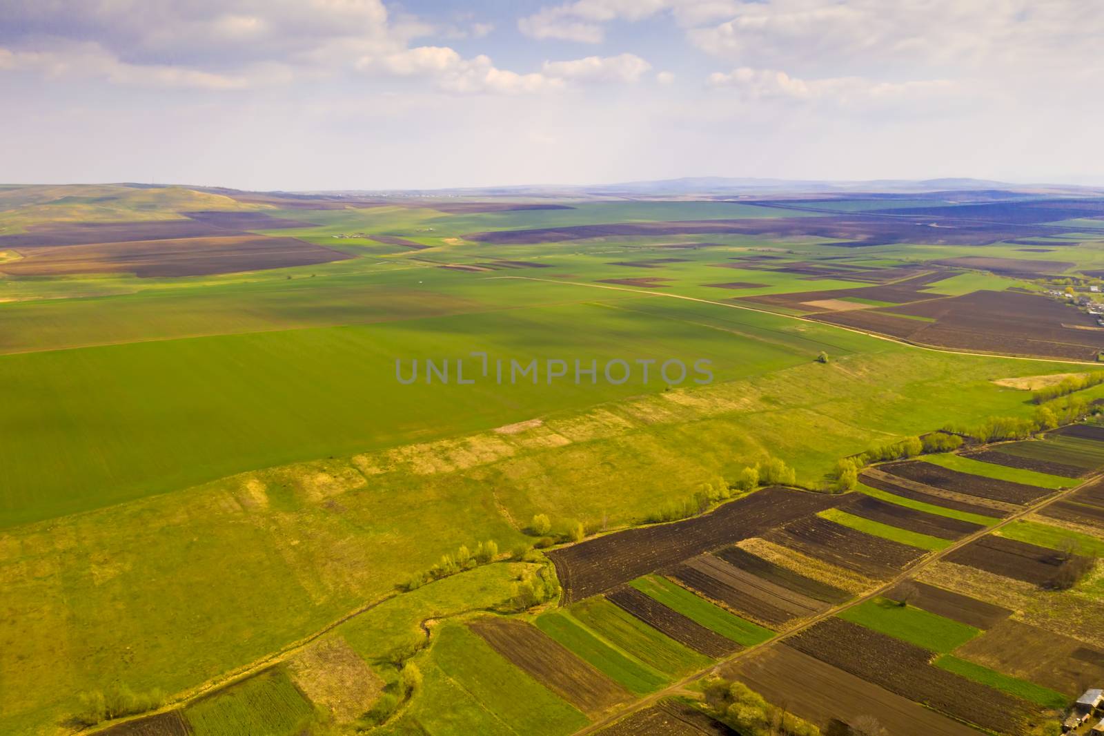 Aerial view of agriculture fields and pasture during springtime,
