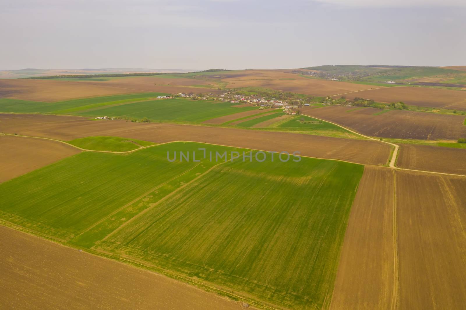 Aerial spring landscape with agriculture fields and village