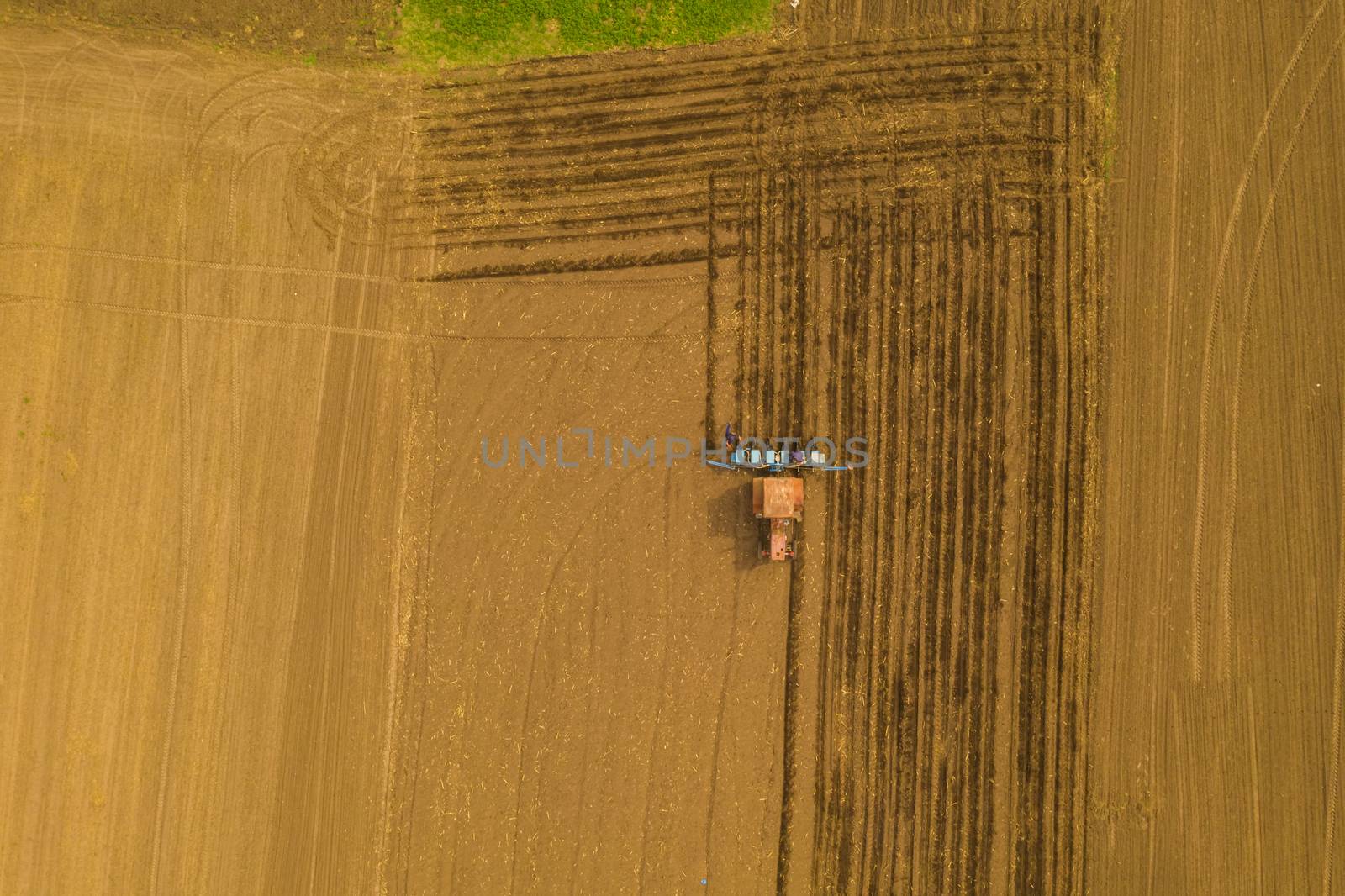 Seeding traktor on spring field, up view